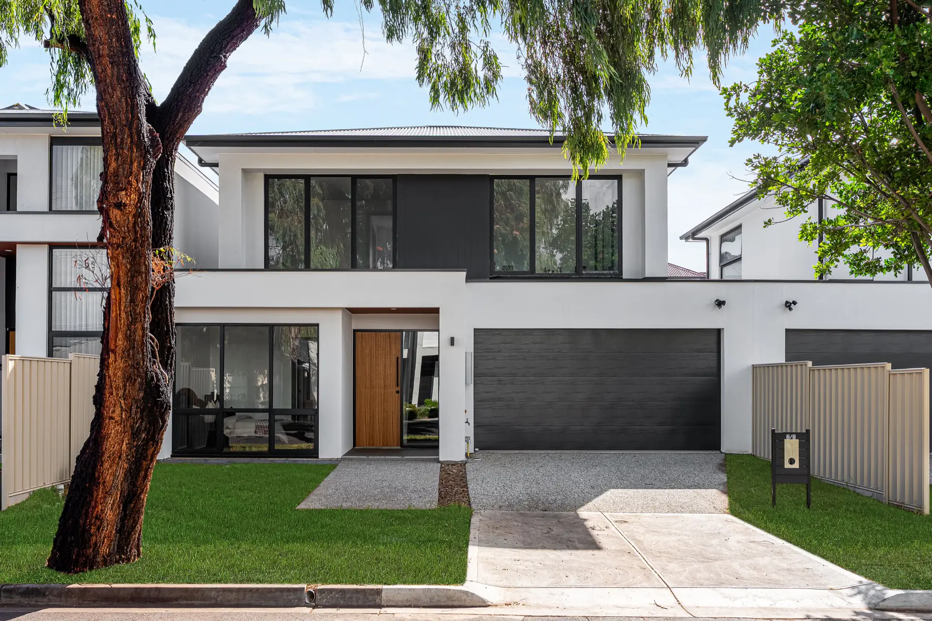 Hill Street Campbelltown residence front facade framed by mature street trees.