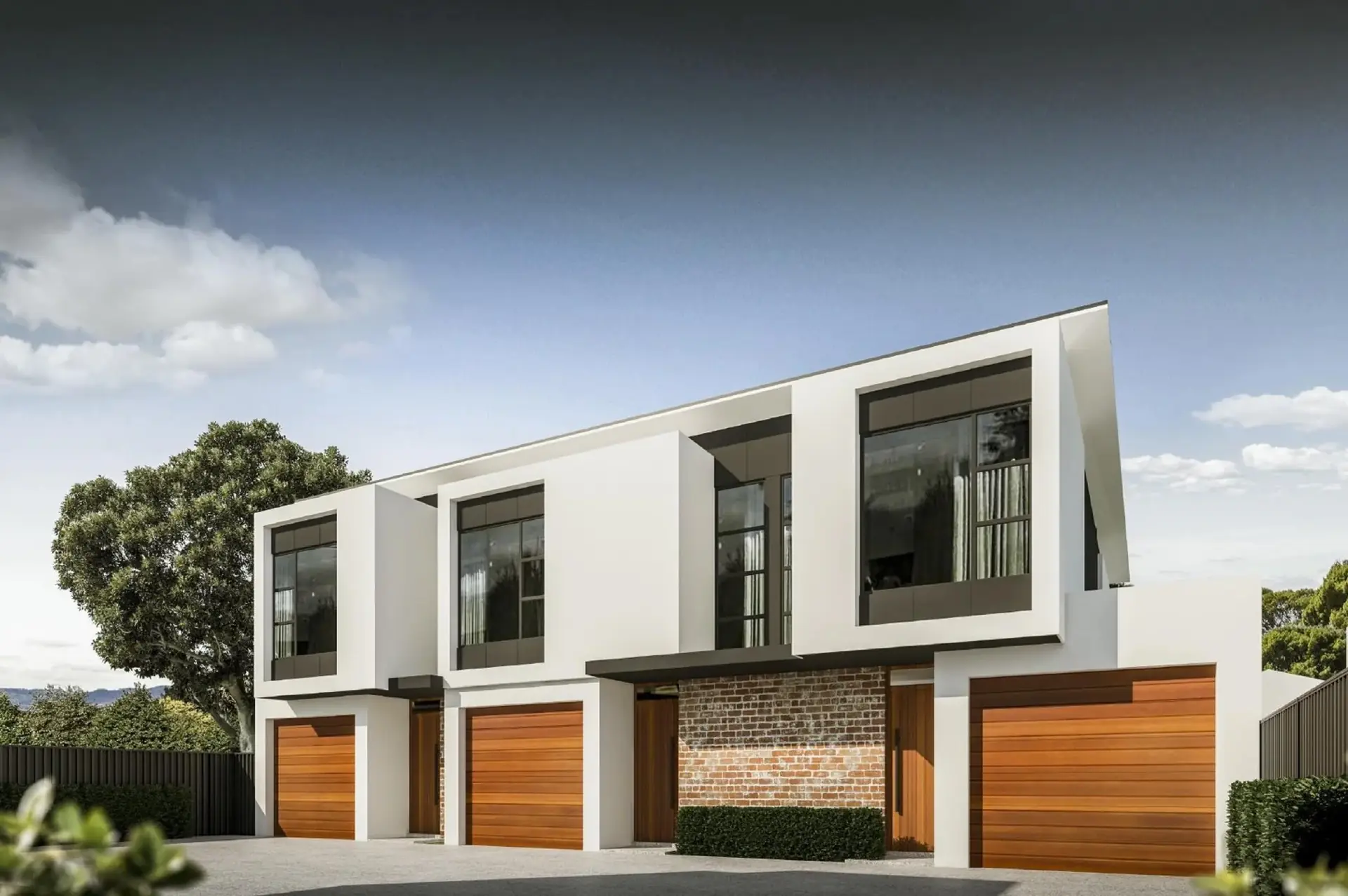 St Bernards Road Rostrevor garage frontage with white rendered frames and timber doors.