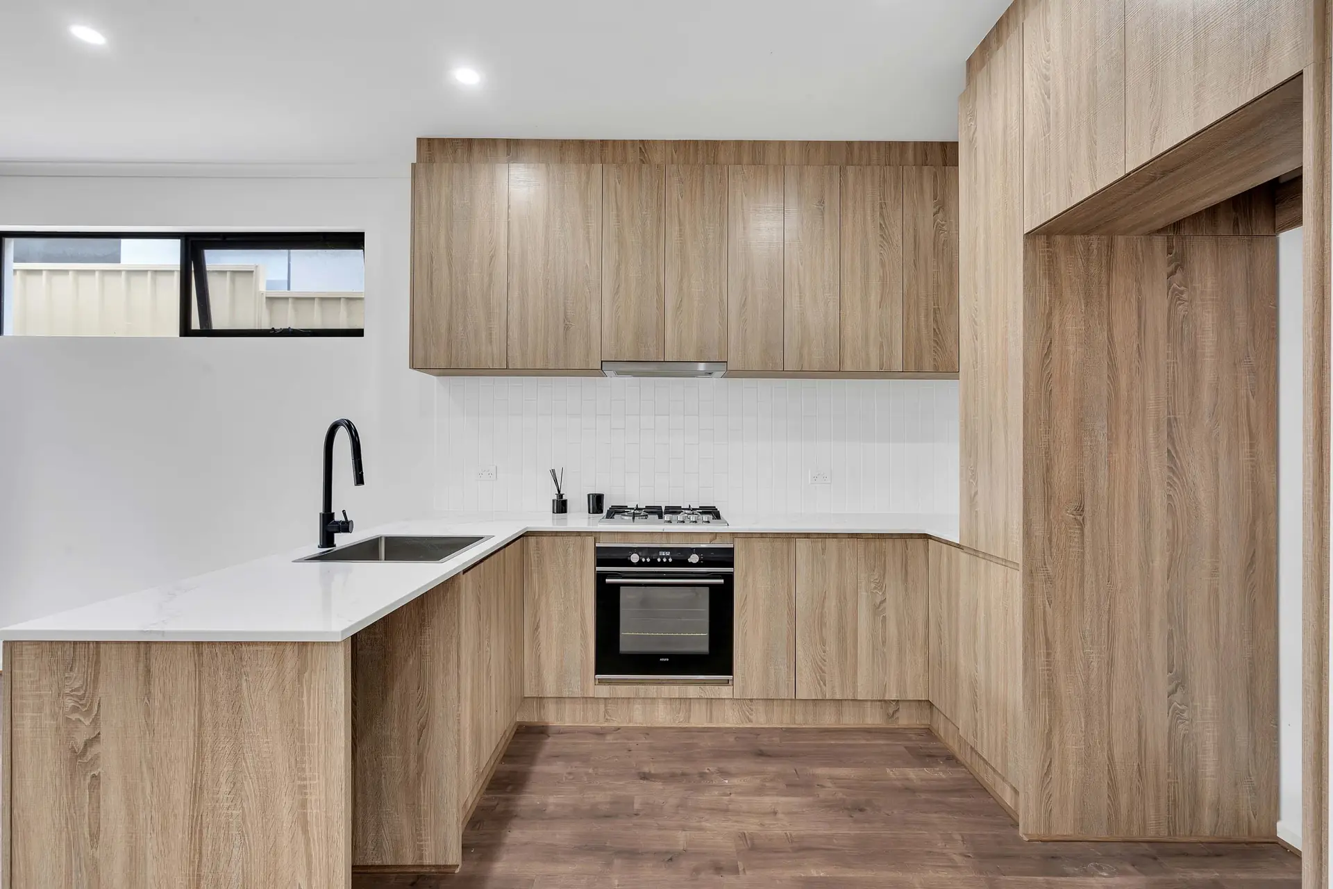 St Bernards Road Rostrevor kitchen with timber cabinetry and white benchtops.