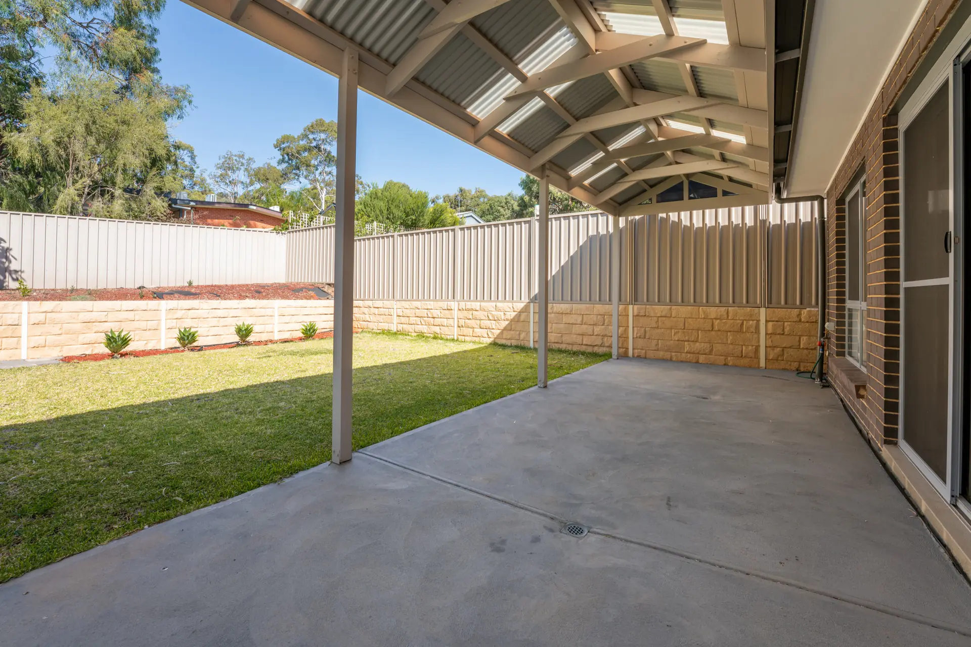 Covered alfresco area and rear lawn at Strathcona Avenue Clapham.