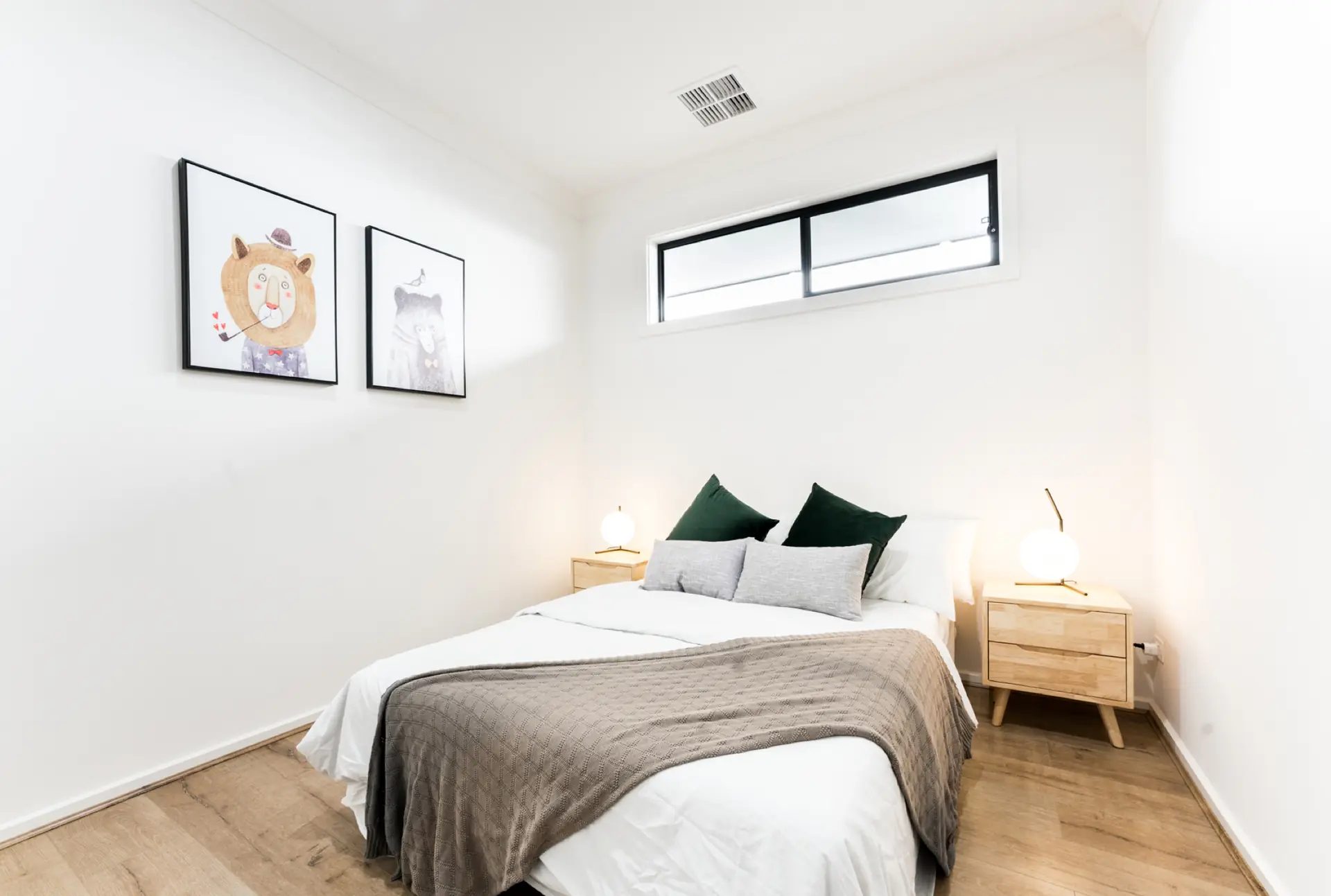 Waterhouse Road South Plympton bedroom with pale flooring and high window.