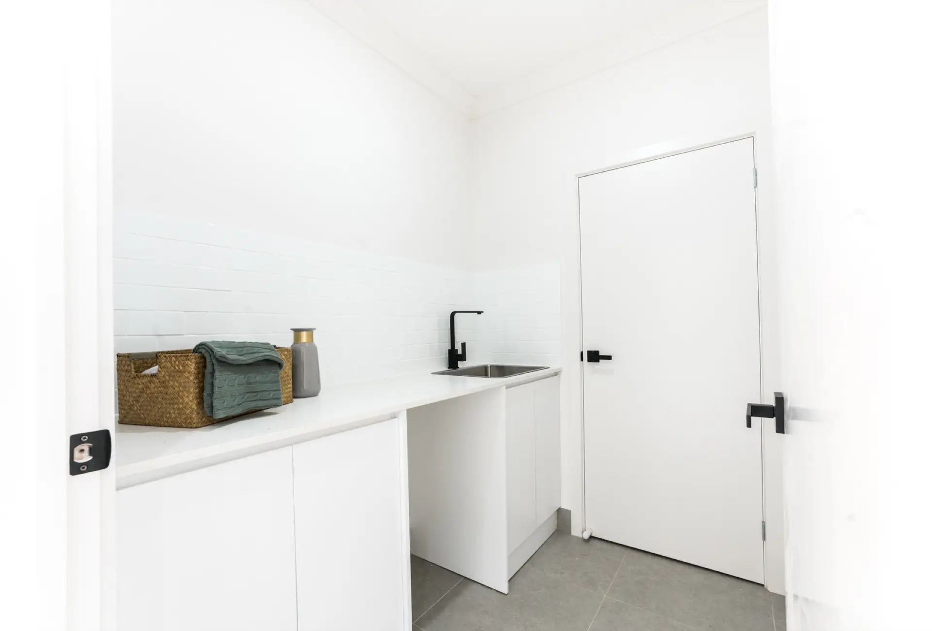 Waterhouse Road South Plympton laundry with white joinery and black tapware.